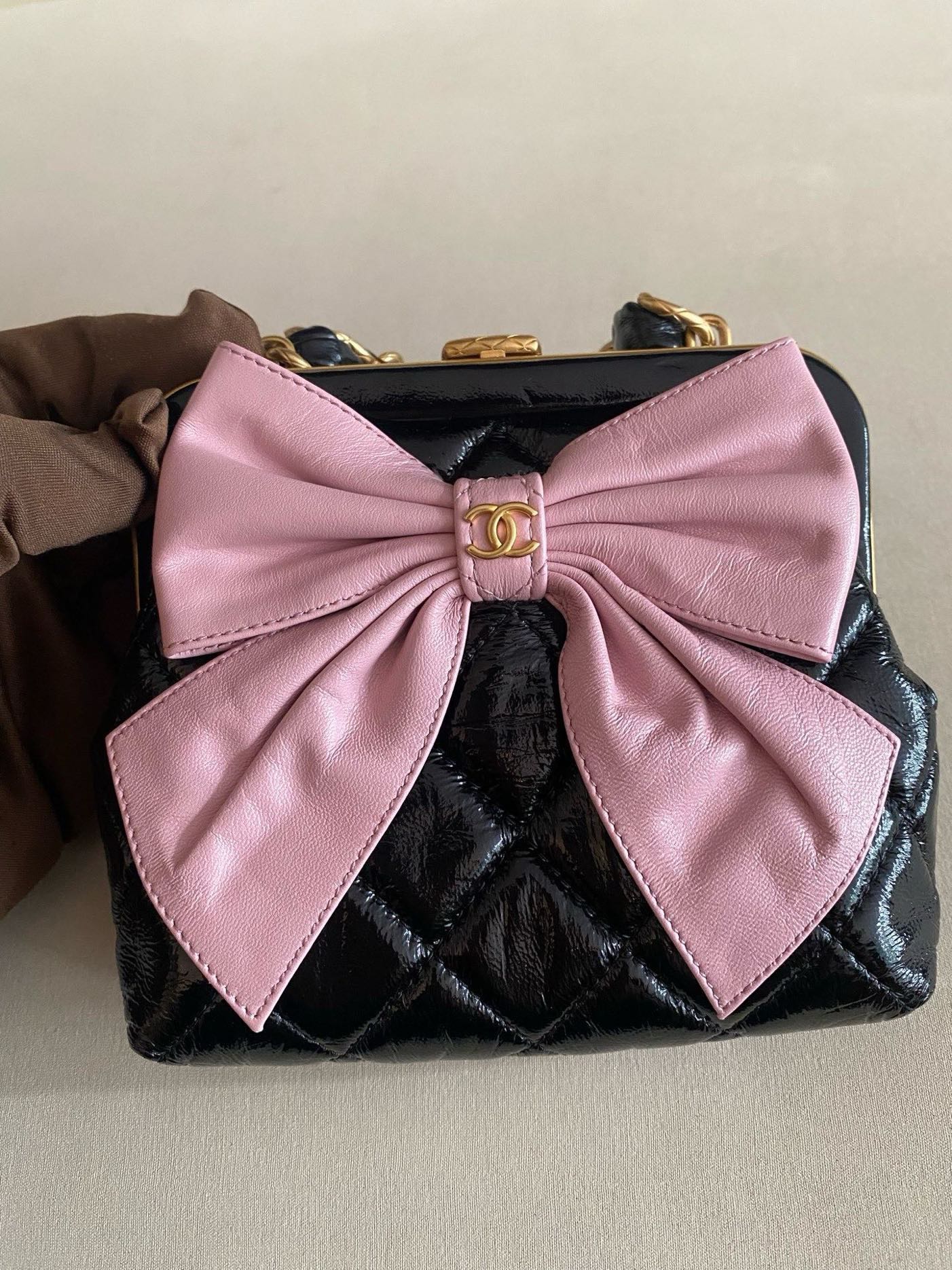 Pre-owned Certified Chanel Ribbon Clutch with Chain in Shiny Black Calfskin with Golden Hardware, microchipped, 2024, w/ dust bag