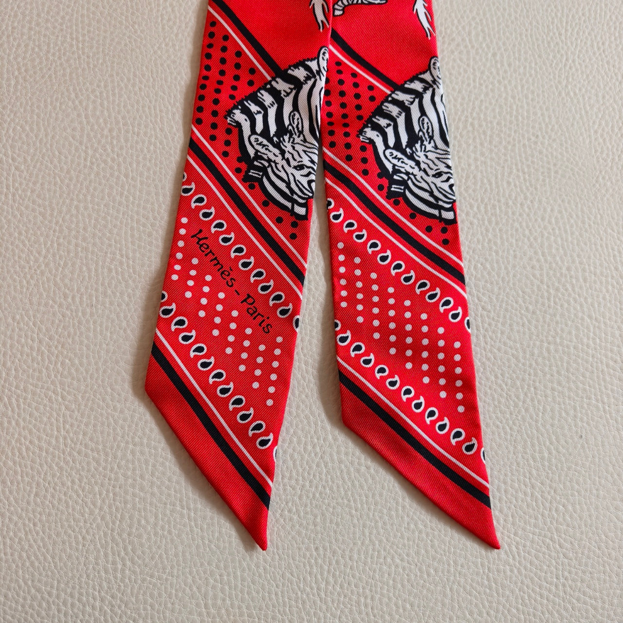 Pre-owned Certified Hermes Silk Twilly “Less Zebres” in Red and White, w/box